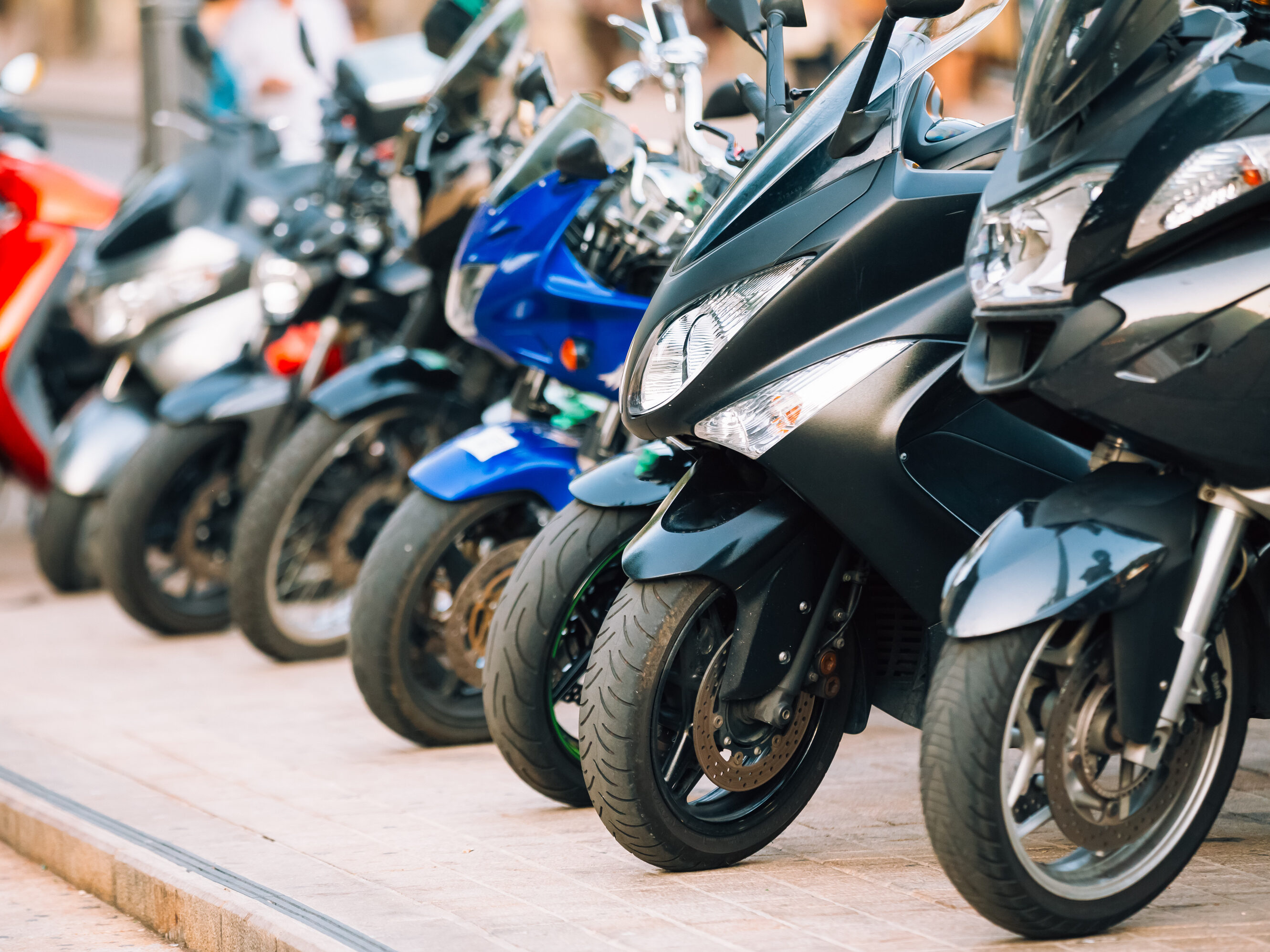 Motorbike, motorcycle scooters parked in row in city street